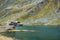 View of alpine Balea lake and valley near Transfagarash highway in mountains of Romania. Tourist view mountain road. Autumn