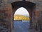 View of Alqueva Lake through an arched doorway in the wall of the town of Monsaraz, Portugal