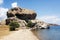 A view of an amazing, wild and sculpture like rock formation on the beach in the island of Patmos, Greece in summer time