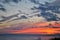 View of the amazing winter sunset and clouds above the surface of the frozen Volga River.