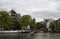 View of Amstel river, parked boats, trees