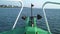 A view of anchor and blue sea in front of a traveling boat in the ocean.