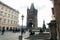 View of the ancient baroque cathedral placed on the crowded street. Prague location.