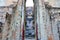 A View of an Ancient Buddha Statue `Phra Achana` inside a Ruined Mandapa of Wat Si Chum in The Sukhothai Historical Park, Thailand