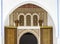 The view of an ancient door with Moroccan style decorative details under an arch wall