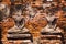 View on  ancient headless busts in front a red brick wall -  Ayutthaya, Thailand