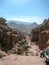 View of ancient Petra from above. Red mountains of Jordanian desert inside which ancient city Petra was carved into stone