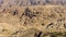 View of ancient Petra from above. Red mountains of Jordanian desert inside which ancient city Petra was carved into stone