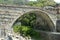 View of the ancient Roman bridge in the town of Pont St Martin in the Aosta Valley - Italy