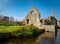 View of ancient ruin of a Norman house over the River Avon through Christchurch, UK