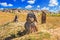 View of the ancient stone idols against the backdrop of mound of sandstone boulders, in the archeological preserve Kamyana Mohyla