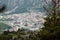 A view of Andorra La Vella from a hike high in the mountains around pine trees, selective focus