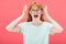 View of angry redhead woman in glasses screaming with closed eyes and t-shirt isolated on pink