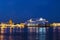 View of the Annunciation bridge and cruise ship Azamara at the pier on the English embankment of the Neva river at night, St. Pete