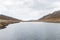 View of another perspective of Laguna Tecllo with some hills and rocks in the morning in Shupluy