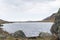 View of another perspective of Laguna Tecllo with some hills and rocks in the morning in Shupluy, Yungay