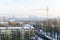 View of apartment houses from the top. Construction crane. Winter time