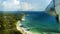 View from the approaching plane on one of the Seychelles Islands and blue, crystal clear sea water