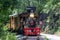 View of an Approaching Steam Passenger Train Blowing Smoke on a Sunny Summer Day