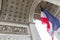 View of Arc de Triomp with flag of France waving in wind on Place de Gaulle in Paris, France