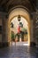 View from arch entrance of Grandmaster Palace Courtyard with maltese flag and two soldier in Valletta