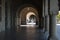 View through the arches on youth people walking