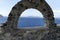 View through archway to aegean sea of santorini island