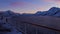 View of the arctic ocean and snow-covered mountains from upper deck of cruise ship near Ã˜ksfjord, Norway in evening light.