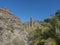 View of arid subtropical landscape of Barranco de Guigui Grande ravine with cacti and palm trees viewed from hiking