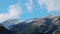 View of Arkhyz mountain peaks and white clouds floating in bright blue sky over mount. Caucasian nature.