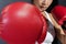 View of Asian Woman with Red Boxing Glove Punching to her Front Opponent