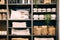 View of assortment of decor for interior shop in store of shopping center. View of shelving with pillows, plaid, baskets