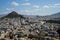 View of Athens city from Acropolis seeing white buildings architecture, Mount Lycabettus, mountain, blue sky and white cloud