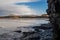 View on Atlantic ocean from a cave by Rosses point beach in county Sligo Ireland, Benbulben mountain covered with snow on the