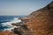 View of the Atlantic Ocean coastline with large waves and white sea foam in La Isleta, Gran Canaria