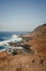 View of the Atlantic Ocean coastline with large waves and white sea foam in La Isleta, Gran Canaria