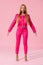 View of attractive, trendy african american woman on pink background, fashion doll concept