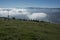 View of Austrian Alps above clouds from the Peterbauerkreuz viewpoint in Grosseck Speiereck