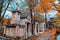 A view on autumn alley of the most famous cemetery of Paris Pere Lachaise, France. Tombs of various famous people