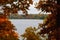 View of the autumn landscape through the branches of trees. Lake Asveja, Dubingiai, Lithuania