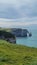 View of the Aval cliff with the arch and the Needle seen from the pebble beach of Etretat in Normandy on a sunny spring morning