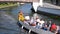 View on Aveiro Moliceiro touristic tour boat crossing the urban water canal of Ria de Aveiro with tourists, Portugal