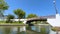 View on Aveiro Moliceiro touristic tour boat crossing the urban water canal of Ria de Aveiro with tourists, Portugal