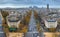 View of avenue des Champs Elysees in Paris from the Arc de Triomphe. Autumn. Rain. Sun.