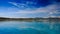 view of azure sea against distant islands blue sky fleecy clouds