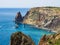 View of the azure sea, jagged cliffs and clear sky.