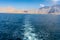 View from the back of a Dhow Boat looking to the Fjords, beautiful blue water, mountains and clouds of Musandam, Oman in the