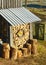 View of the backyard in the early spring morning, firewood for the winter, in front of the barn