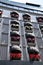 View of the balconies of the house. Beautiful balconies on the facade of the building with red flowers