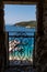 View through a balcony of the Badiali Castle on the island of San Nicola, Tremiti Islands and ours the splendid blue sea